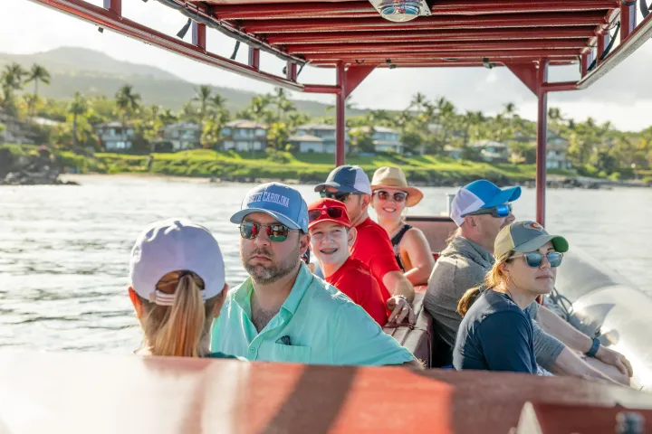 a group of people on a boat in the water