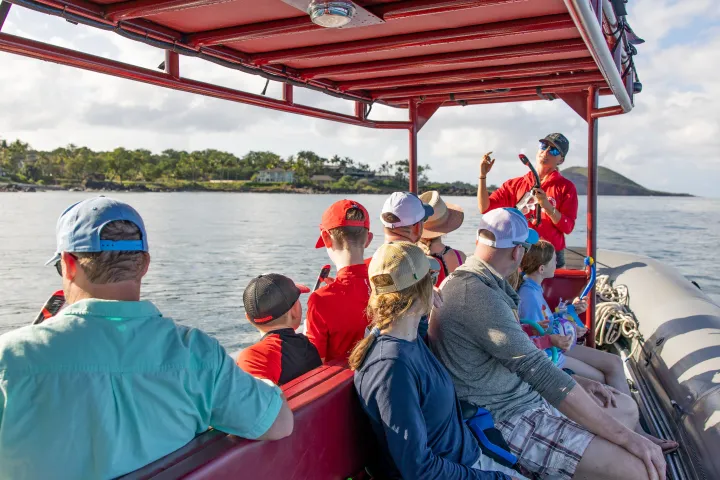 a group of people in a boat on a body of water
