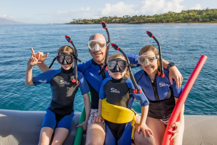 a group of people in a boat on a body of water