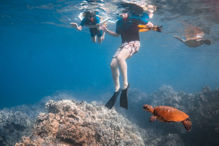 a man riding a wave on a surfboard in the water