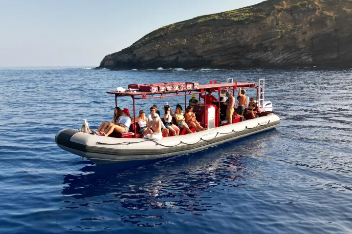 a group of people in a small boat in a body of water