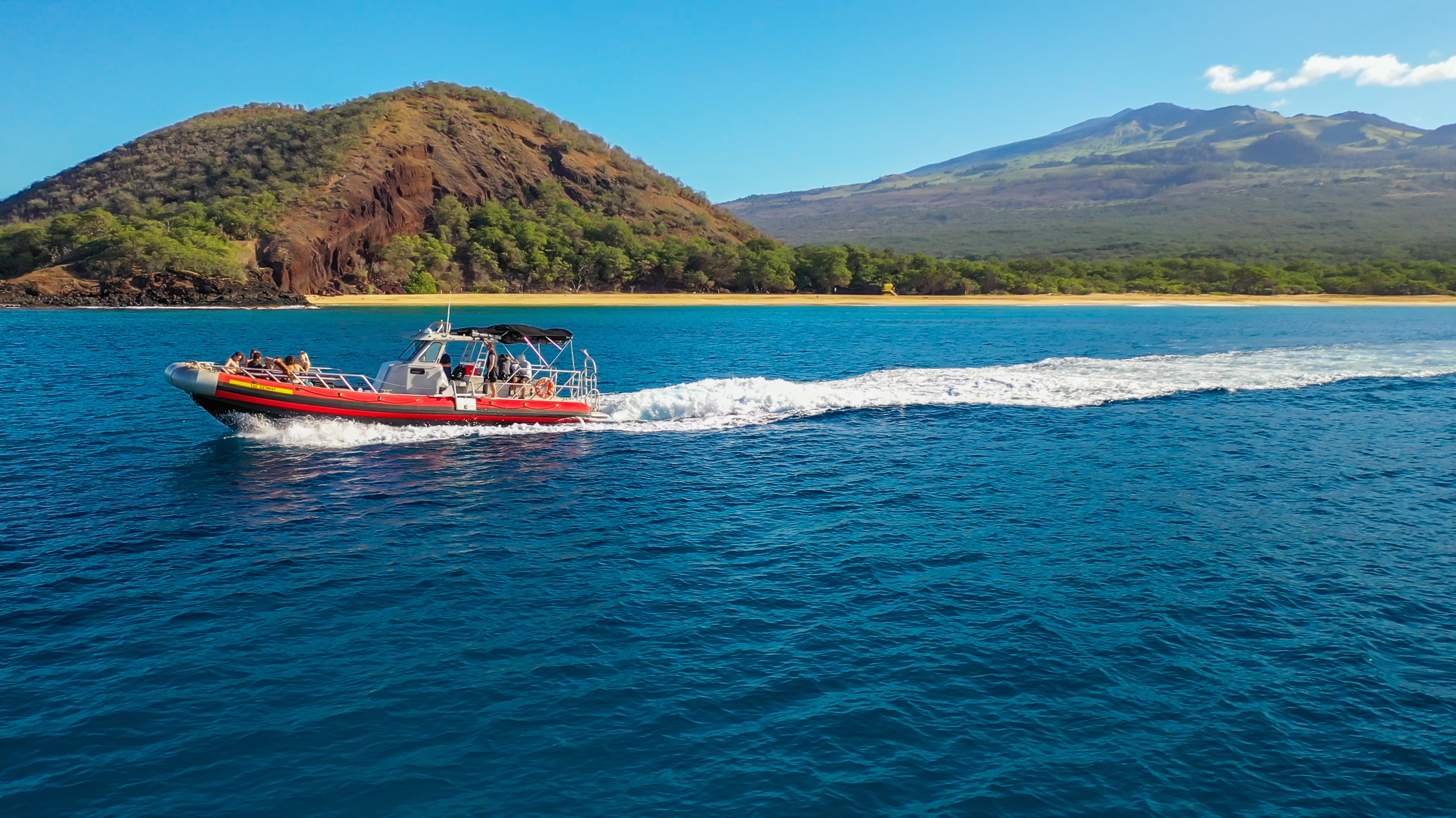 a small boat in a body of water with a mountain in the background