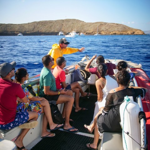 a group of people in a boat on a body of water