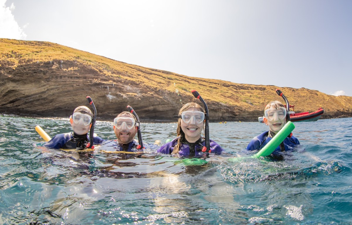 A family snorkeling at Molokini Crater in Maui, Hawaii.