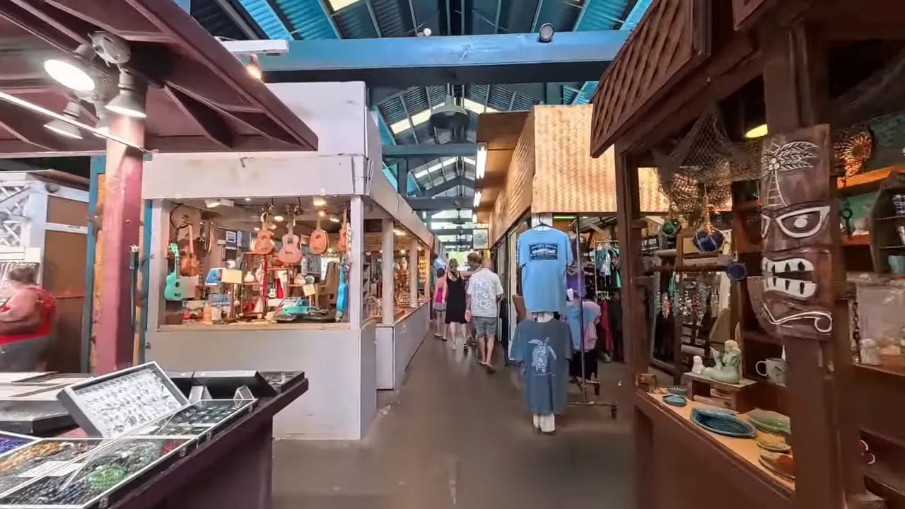Indoor open-air market corridor with jewelry displays and souvenir shops at Kihei Kalama Village